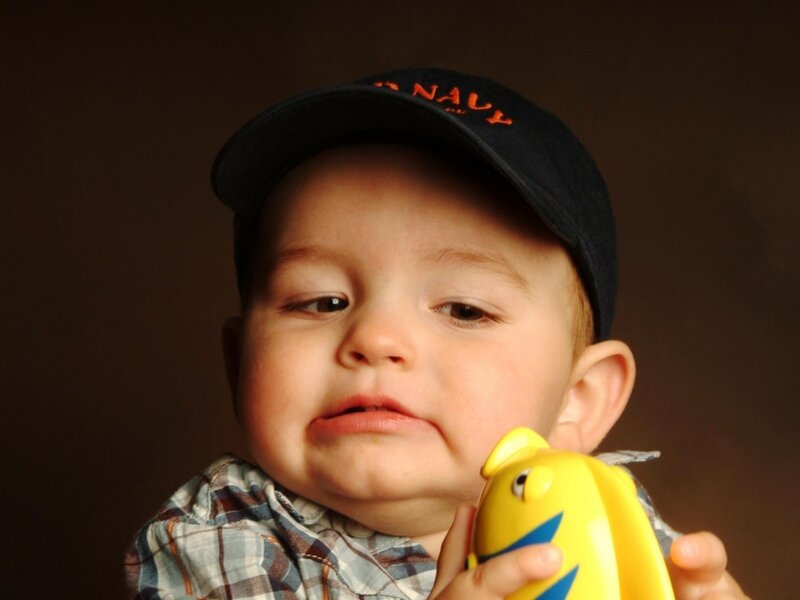 Baby Holding Toy Fish