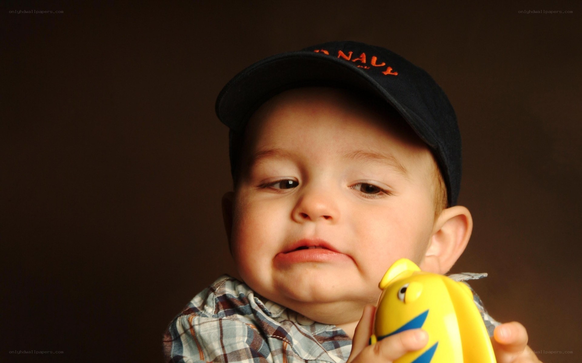 Baby holding yellow toy