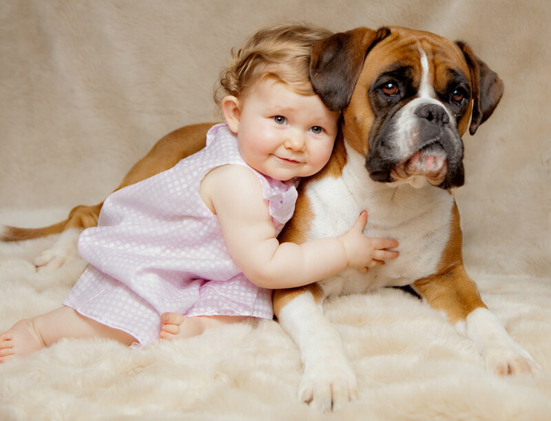 Baby Hugging Boxer Dog
