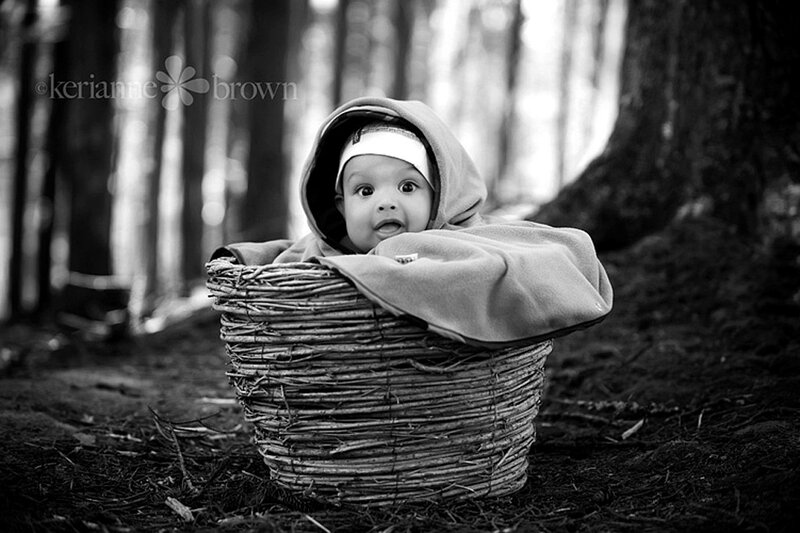 Baby in a basket in the woods