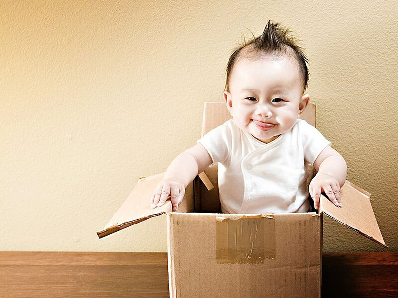 baby in a cardboard box
