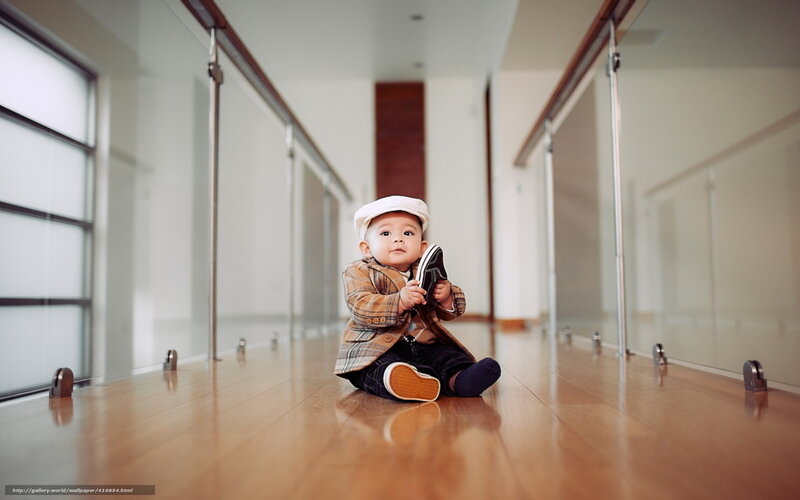 Baby in a hallway with a shoe