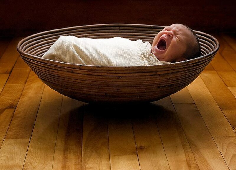 baby in a woven basket