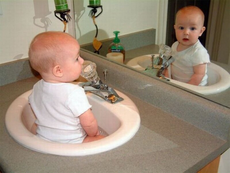 Baby in bathroom sink