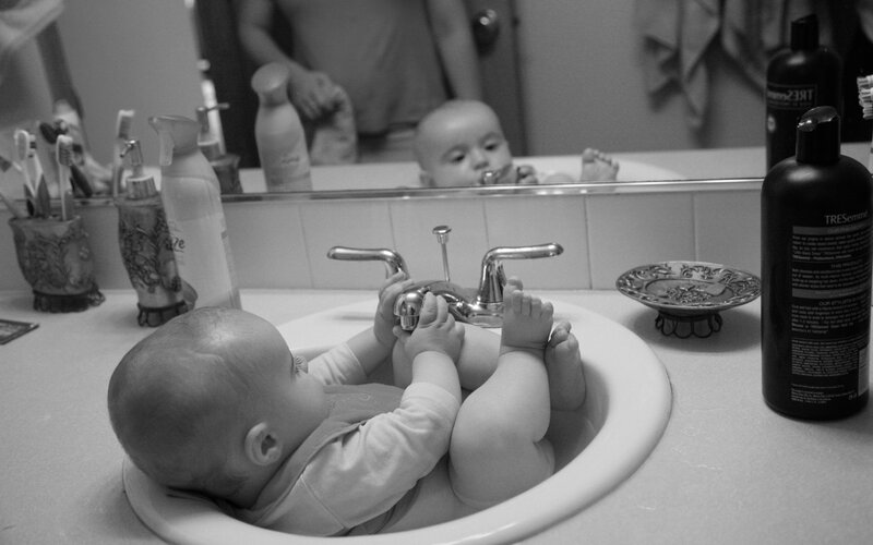 Baby in Bathroom Sink — Black, Calm