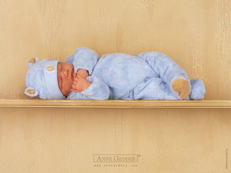 Baby in blue bear outfit
