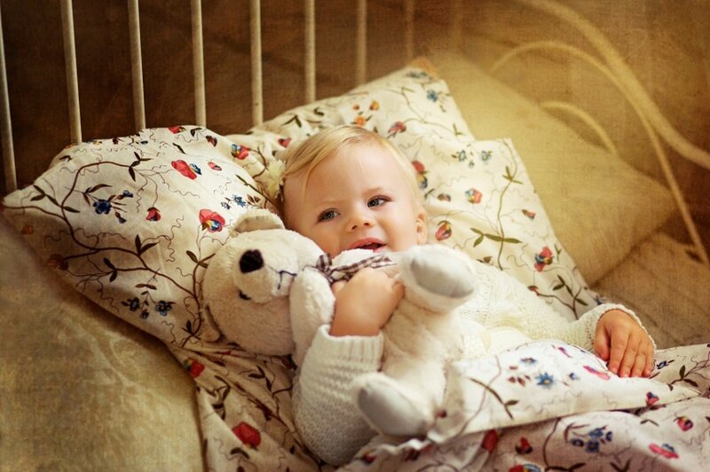 Baby in Crib with Teddy Bear
