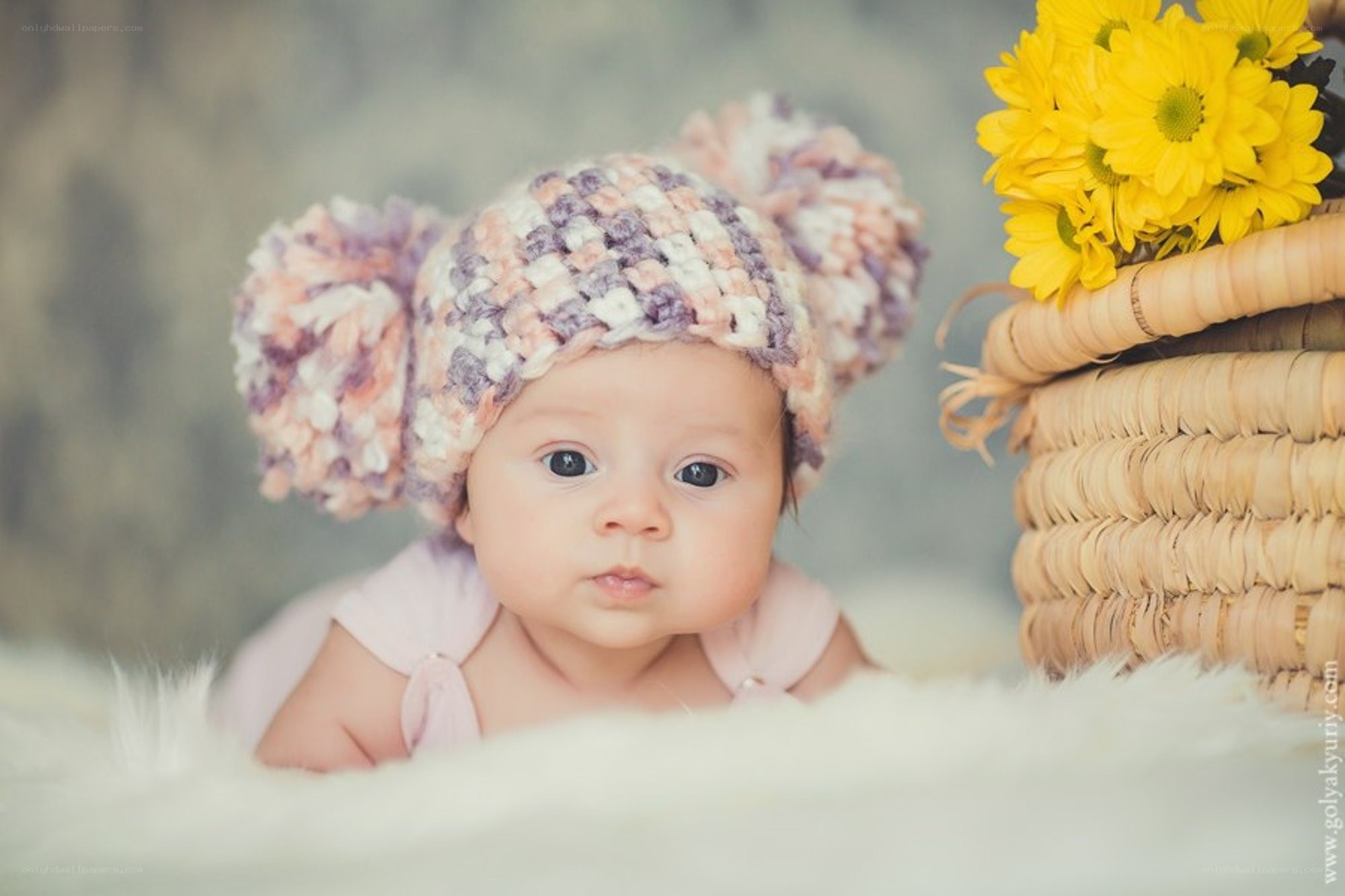 Baby in crocheted hat with flowers