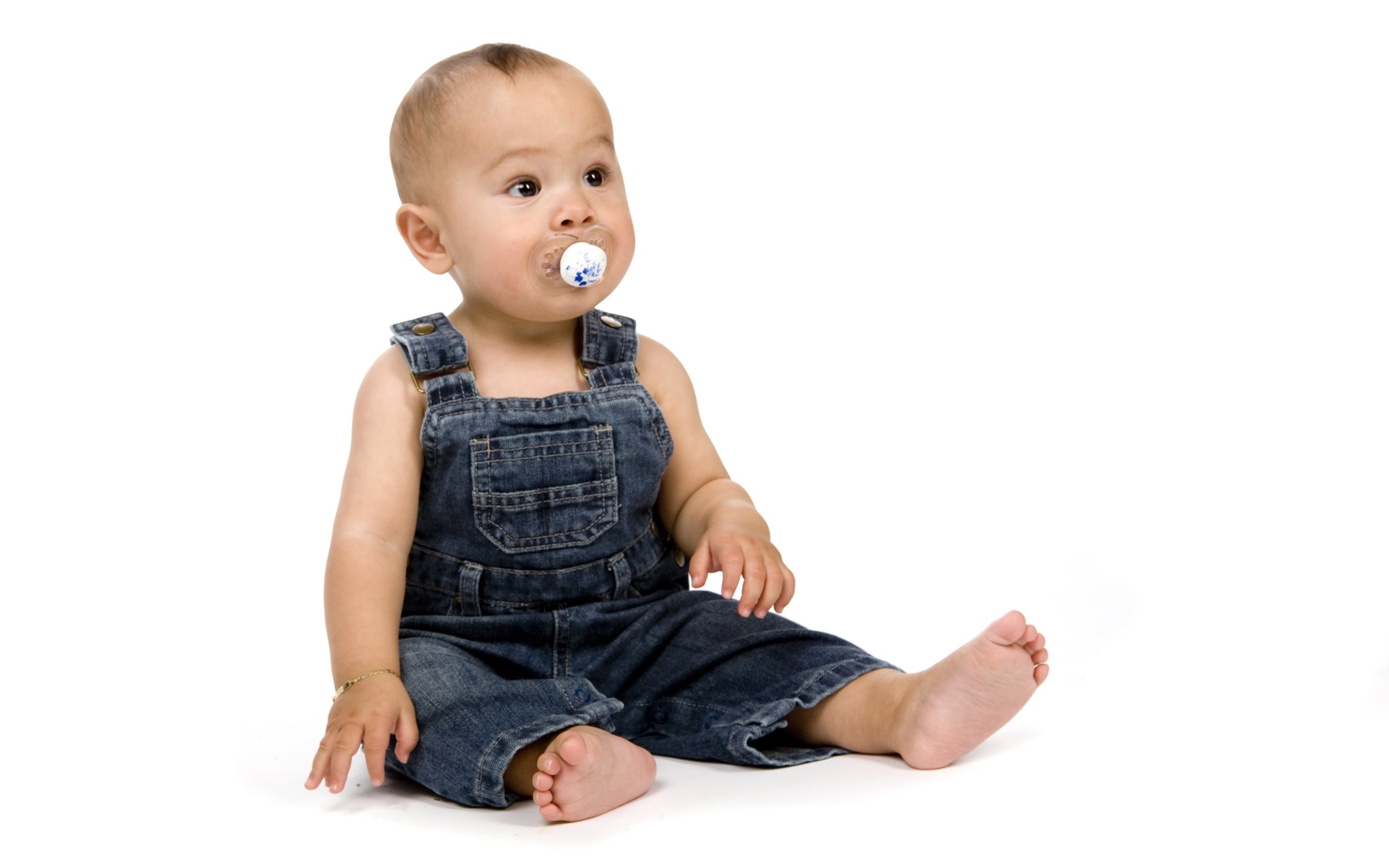 baby in denim overalls