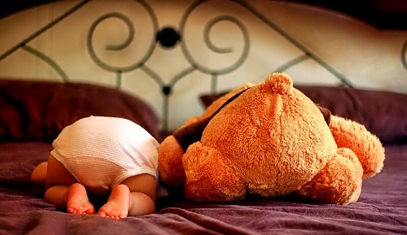 Baby in Diaper on Bed