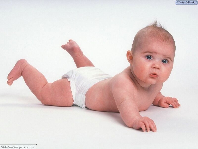 Baby in diaper on white floor