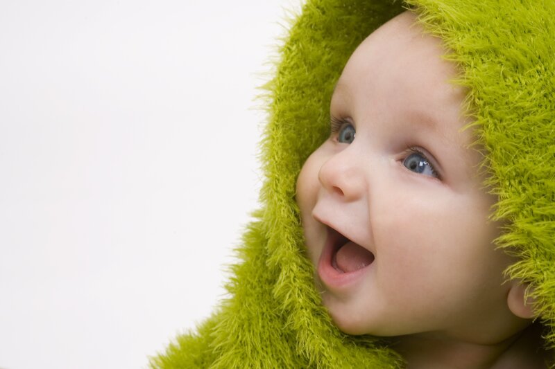 baby in green hooded blanket