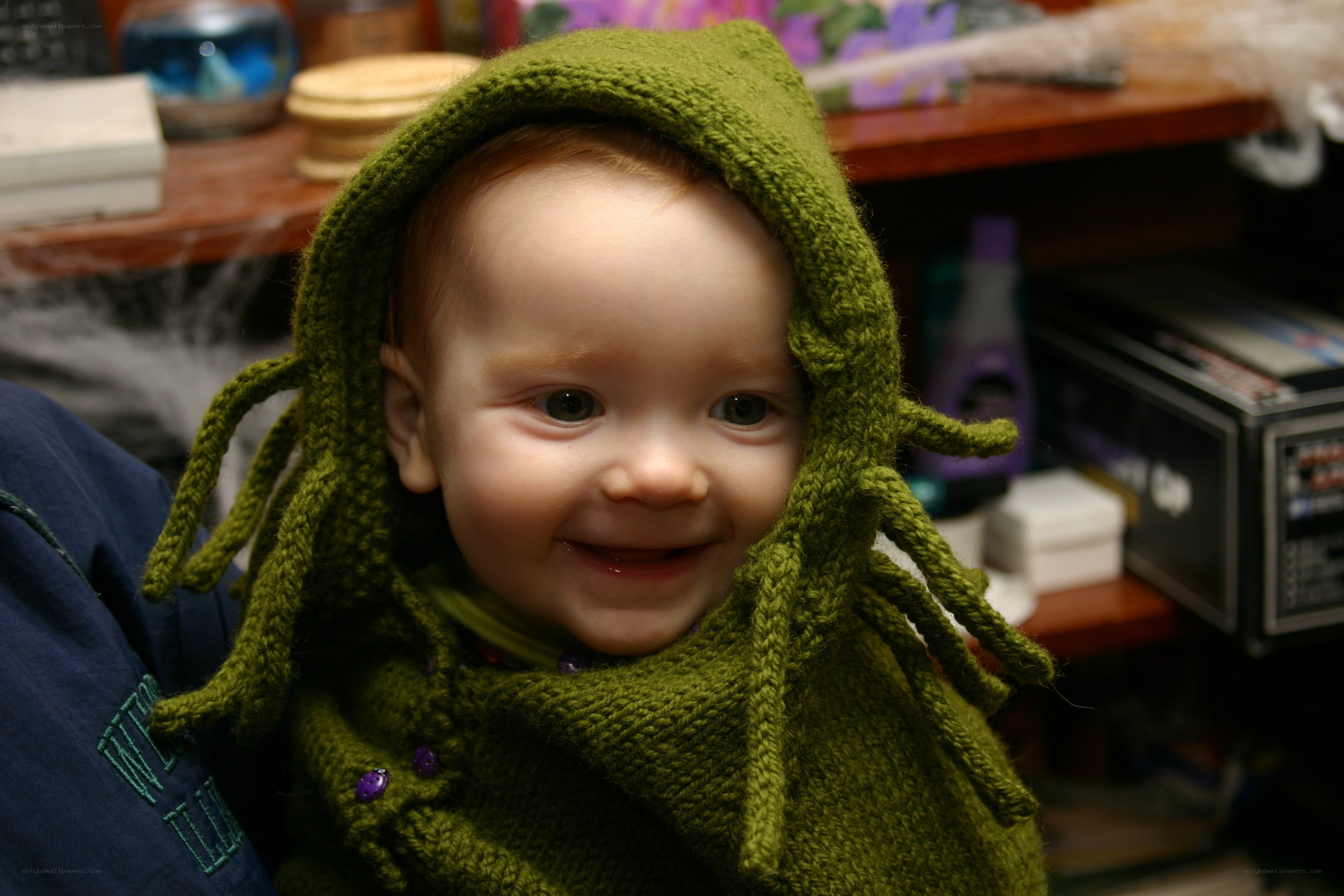 Baby in green knitted hat