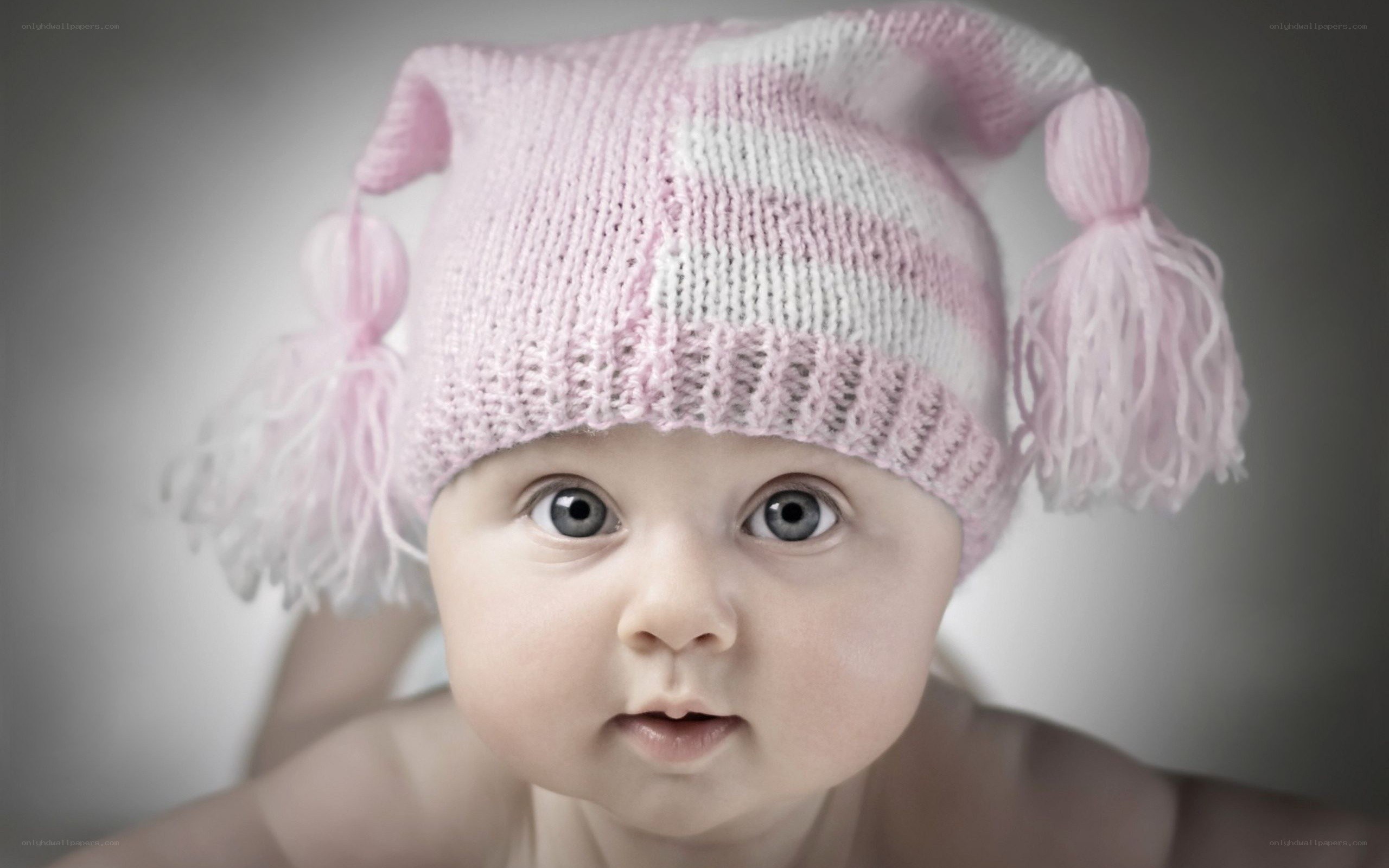 baby in pink knitted hat