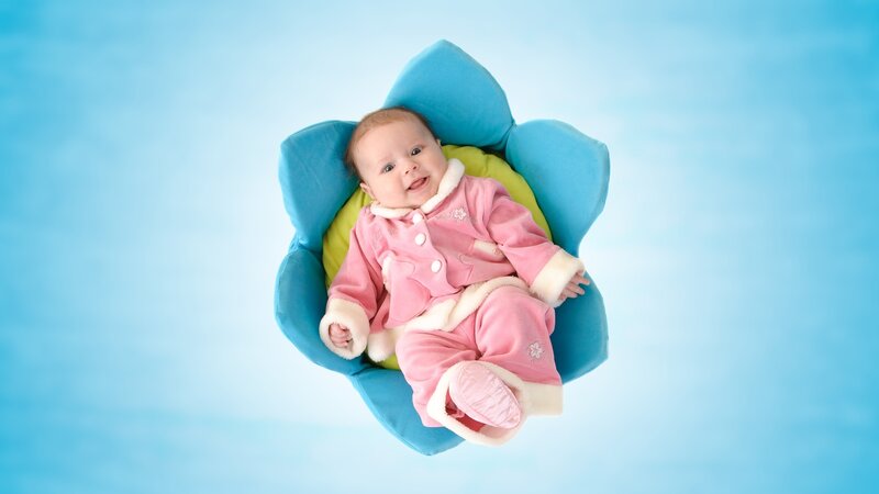 Baby in pink outfit smiling