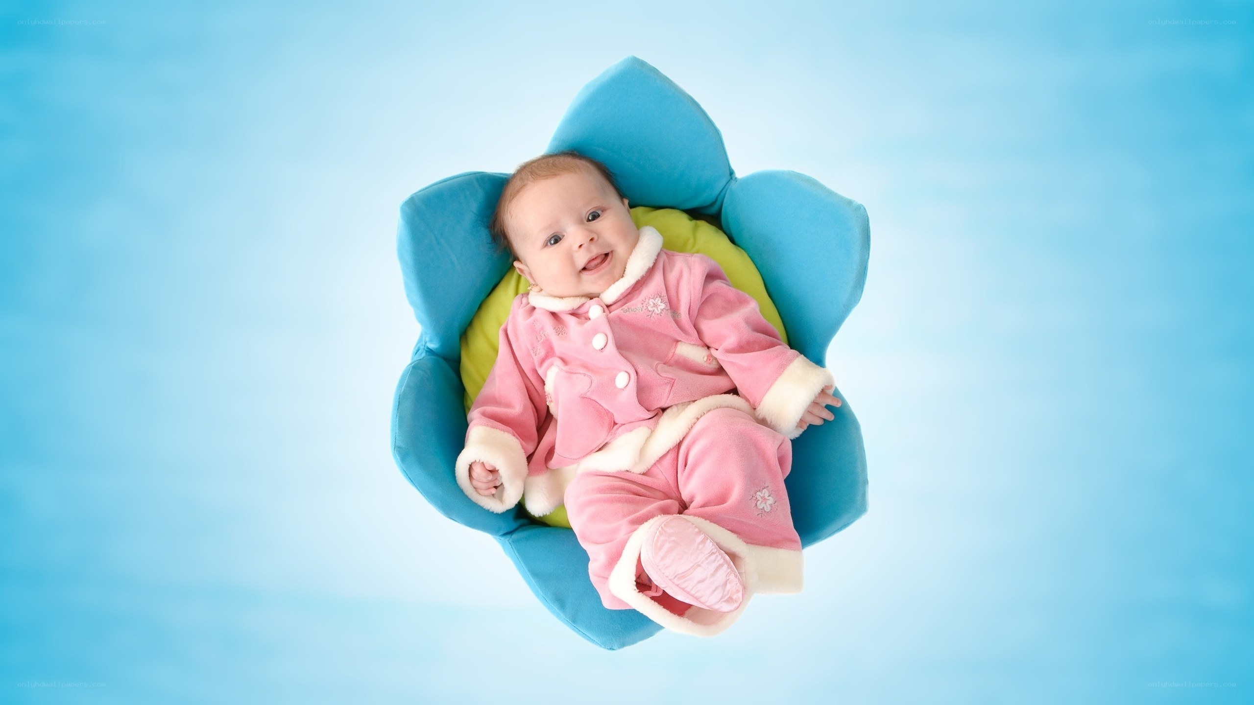 Baby in pink outfit smiling