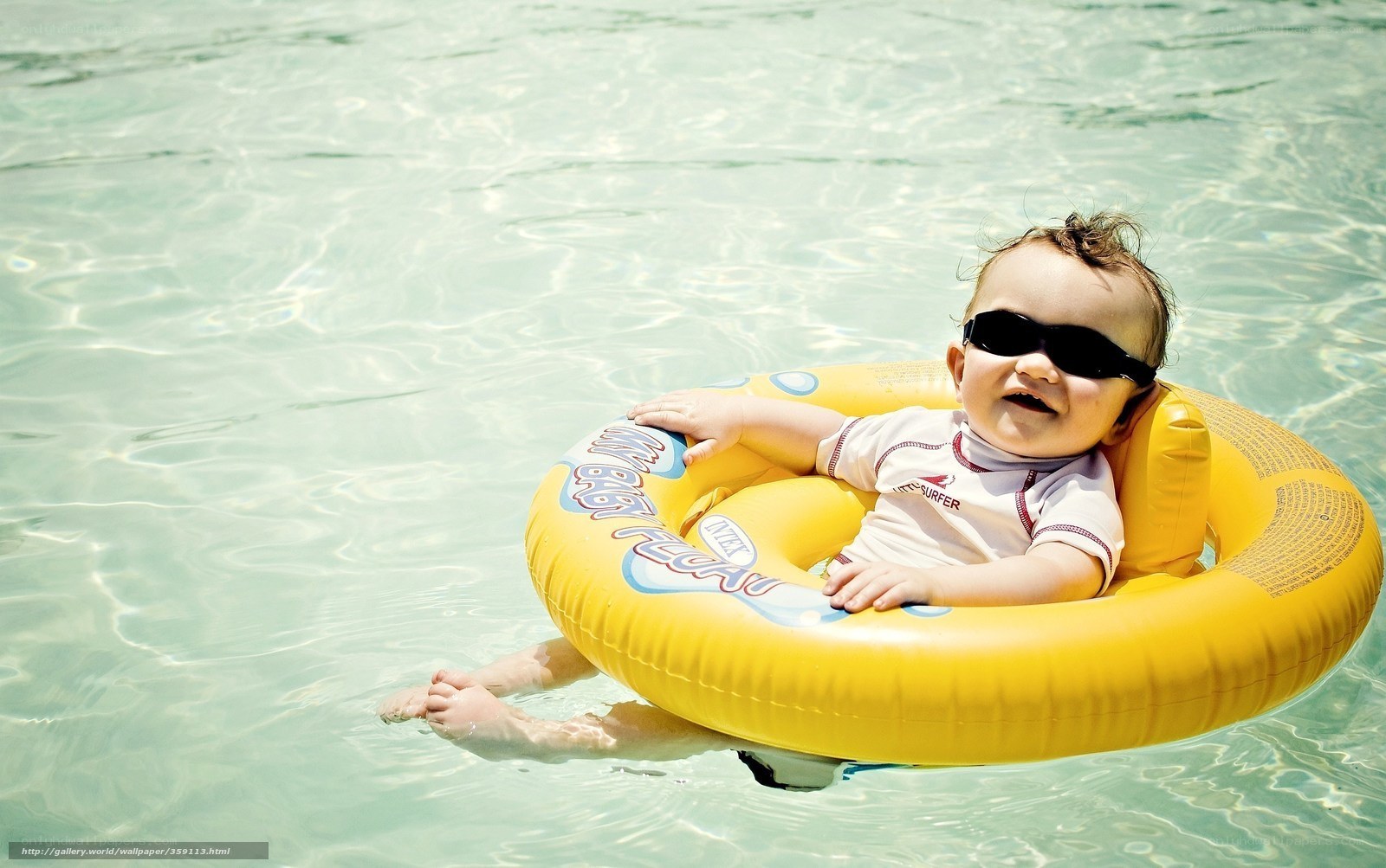 Baby in pool with floatie