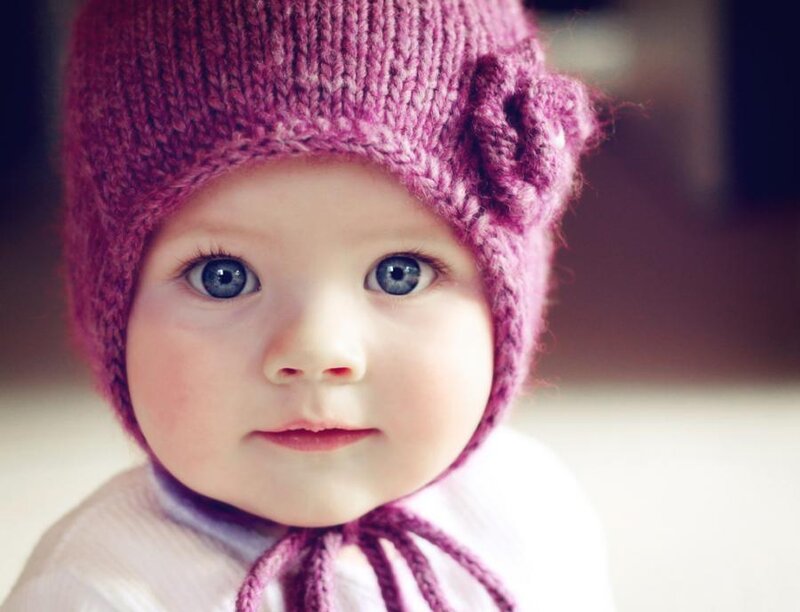 baby in purple knit hat