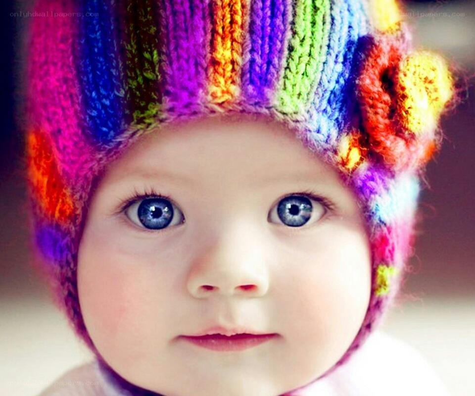 baby in rainbow hat