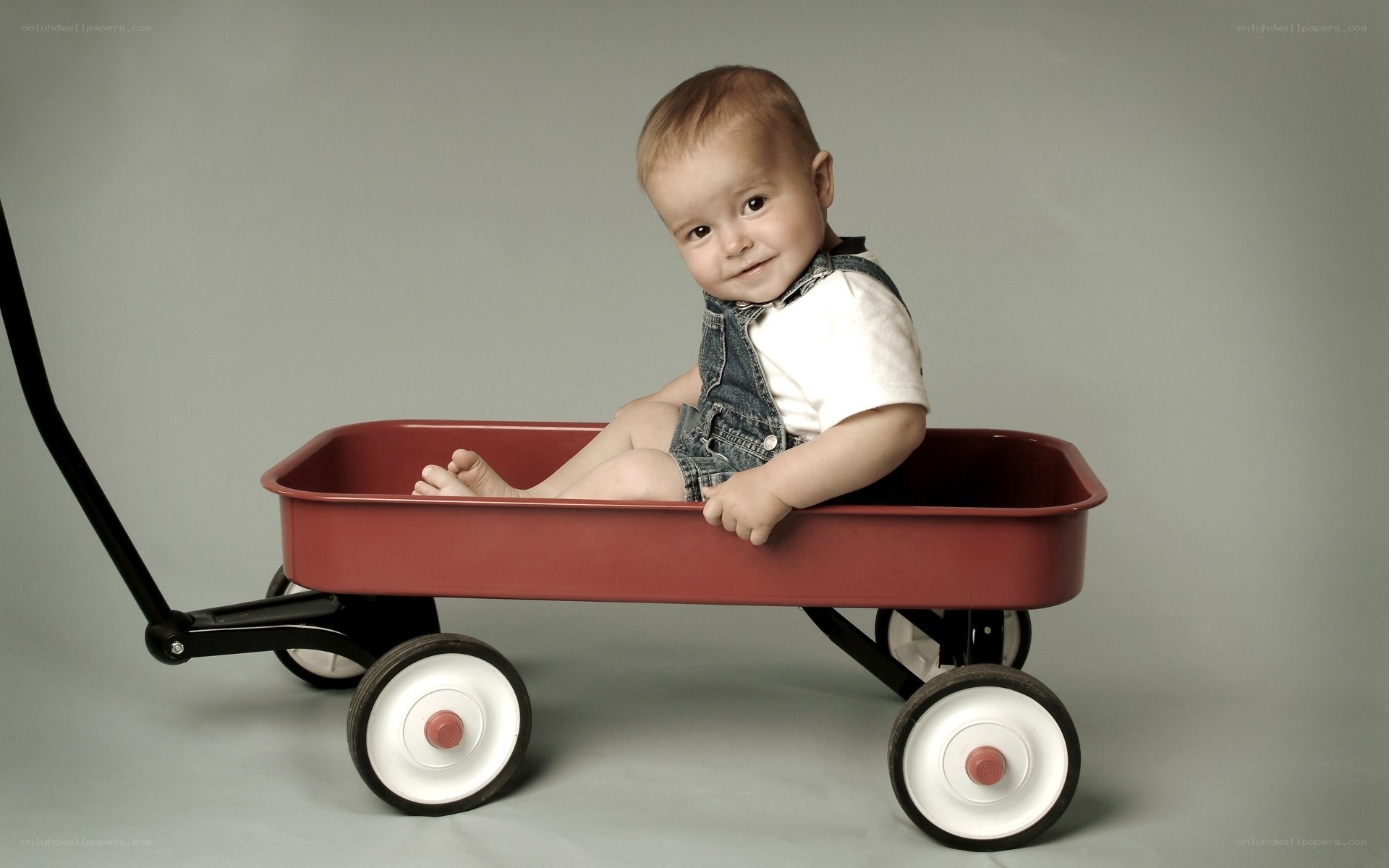 Baby in red wagon
