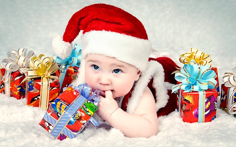 Baby in Santa hat with gifts