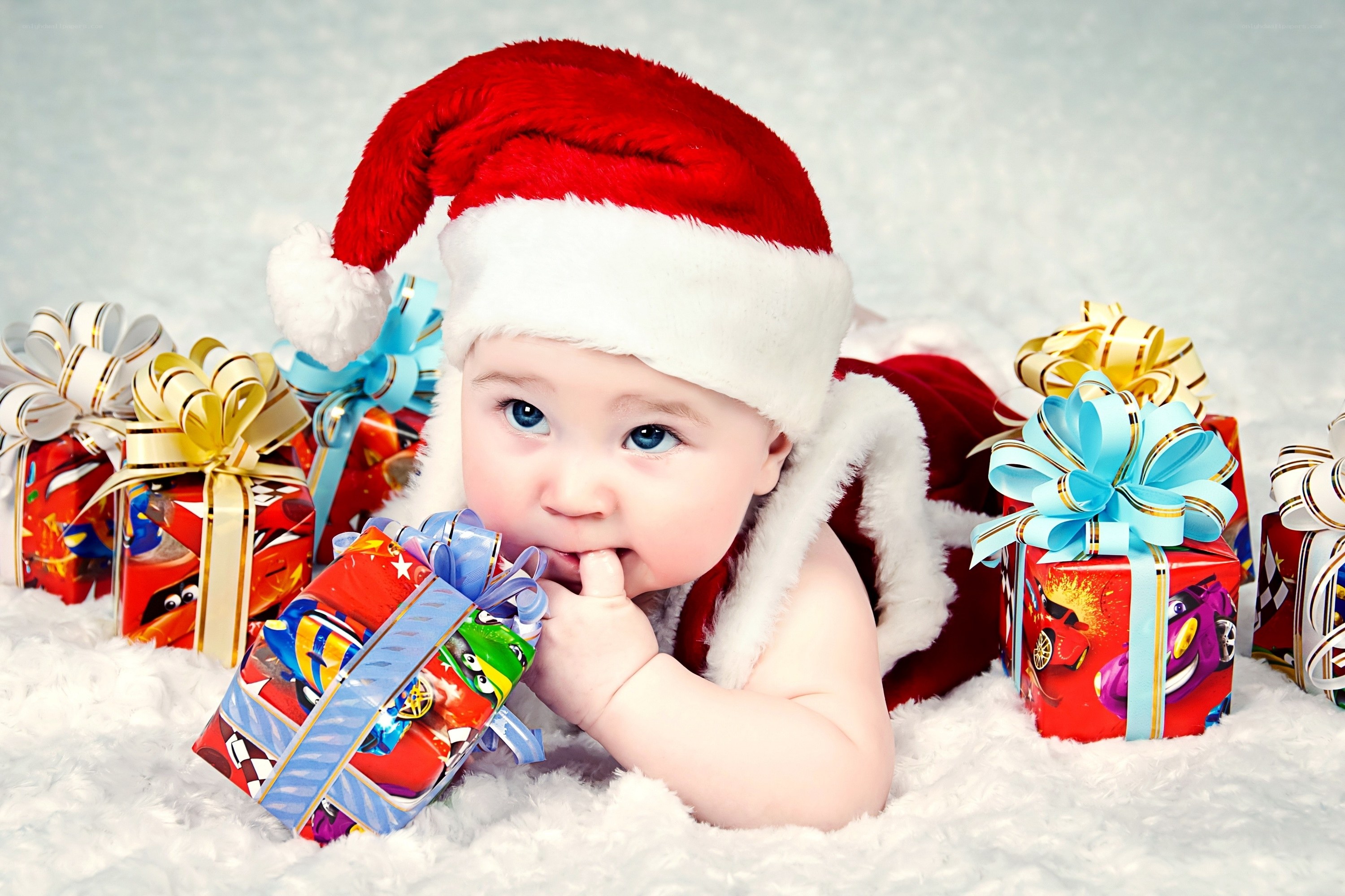 Baby in Santa hat with gifts
