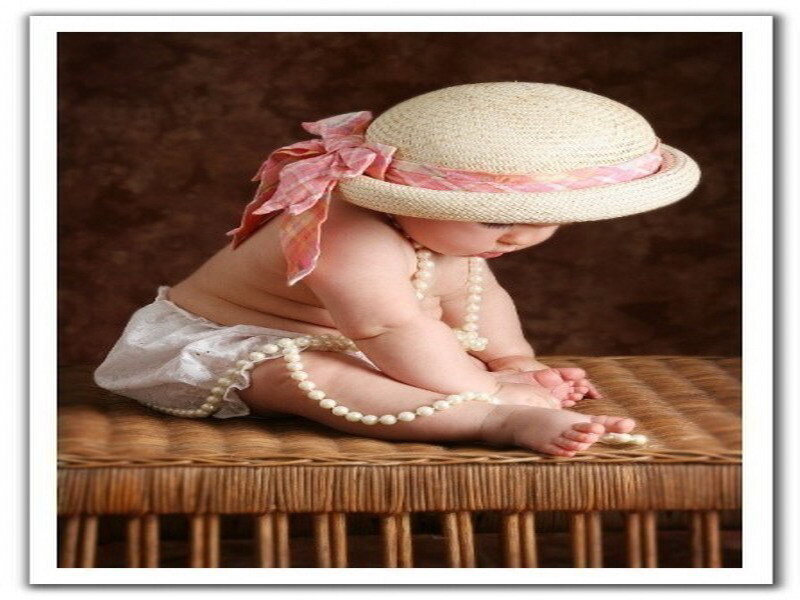 Baby in straw hat and pearls