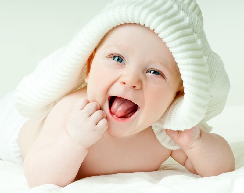 Baby in White Blanket — Happy