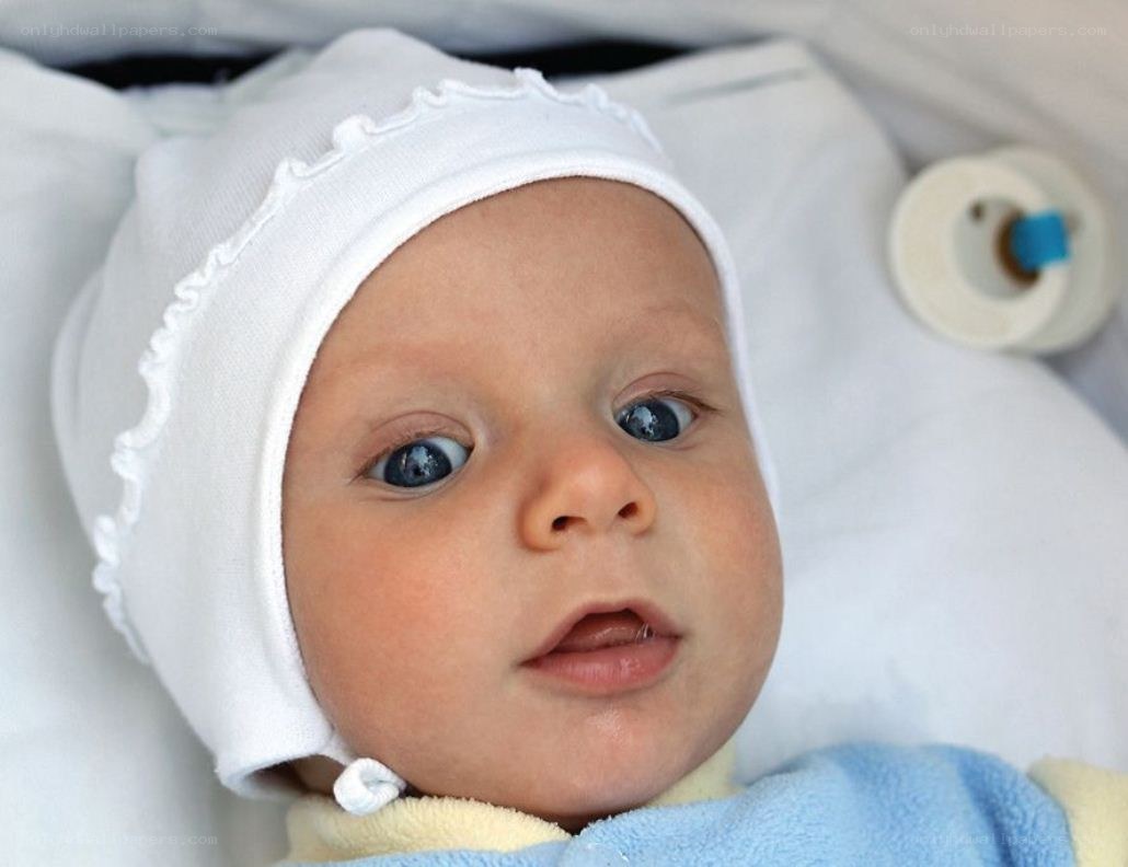 baby in white bonnet