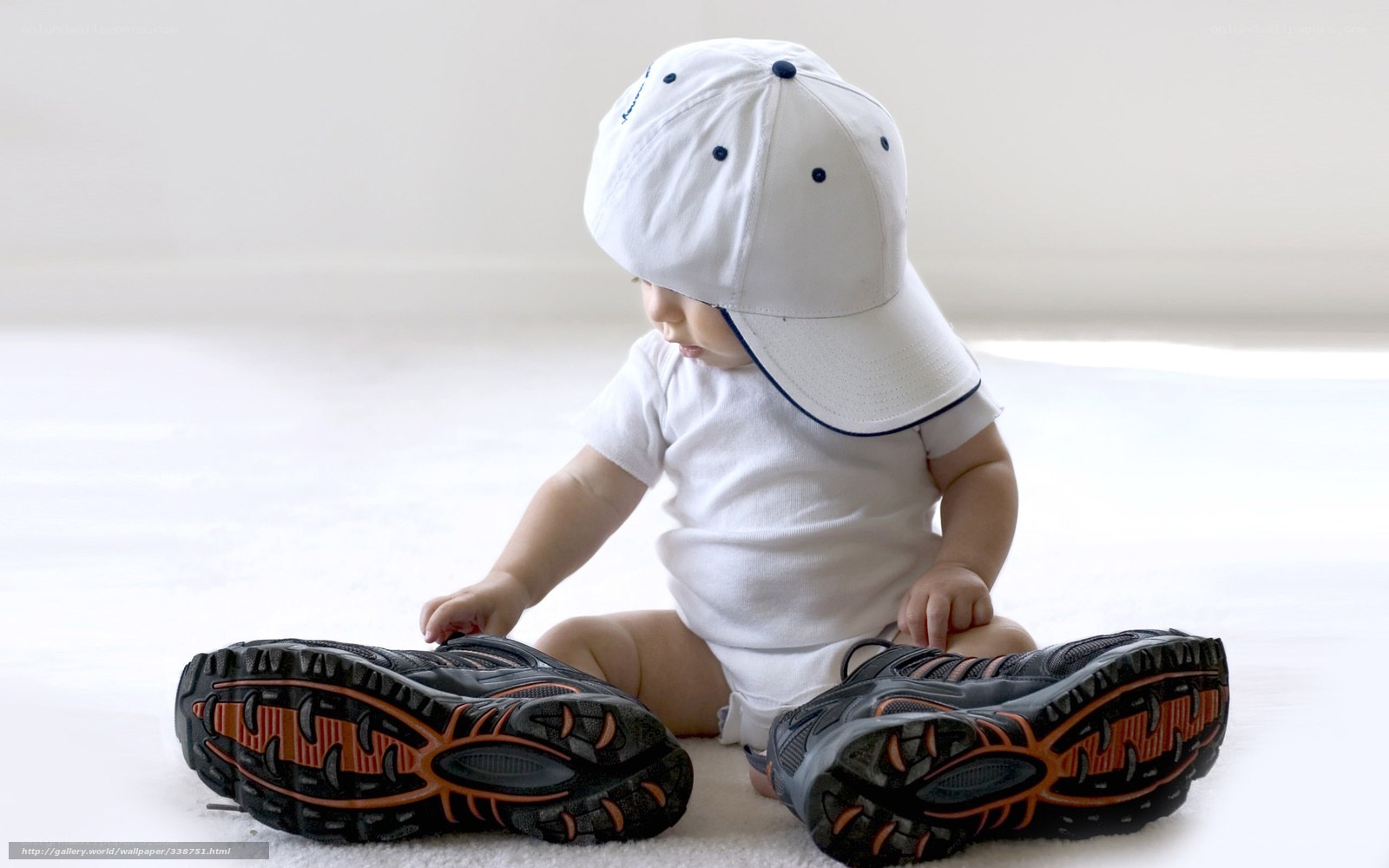 Baby in white cap and sneakers