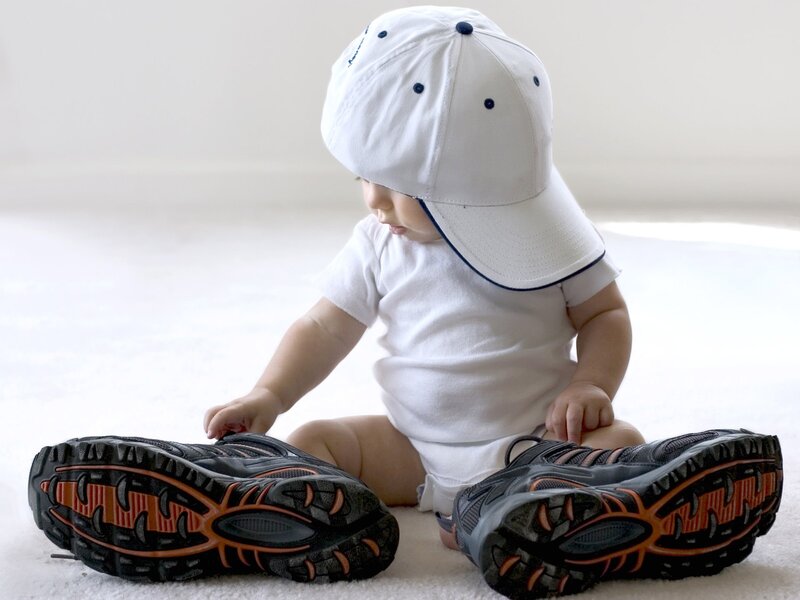 Baby in white cap and sneakers