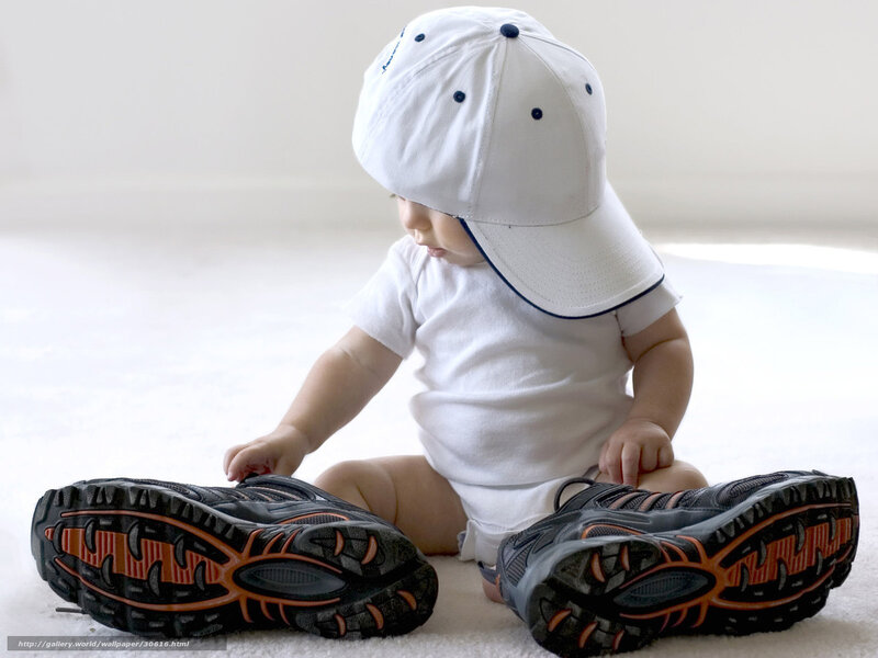 Baby in white cap and sneakers