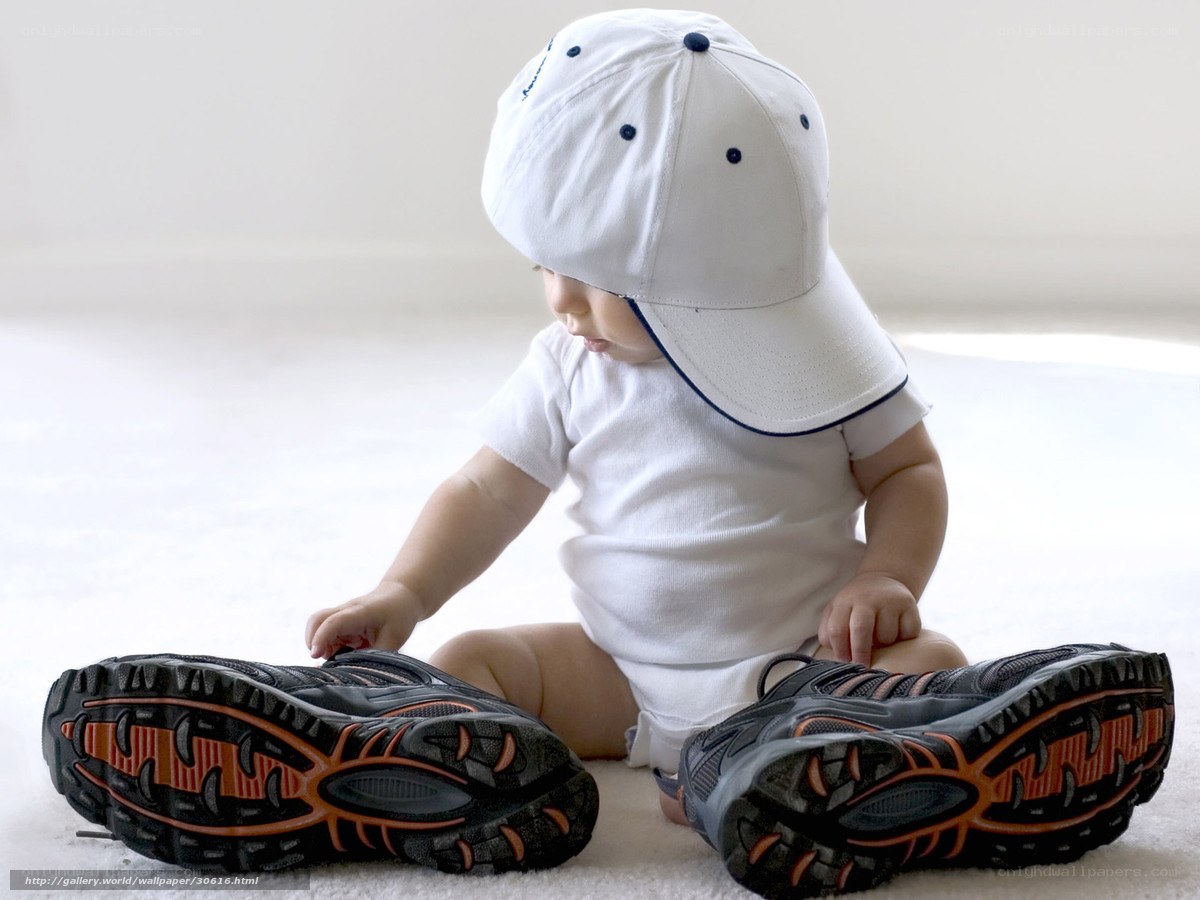 Baby in white cap and sneakers