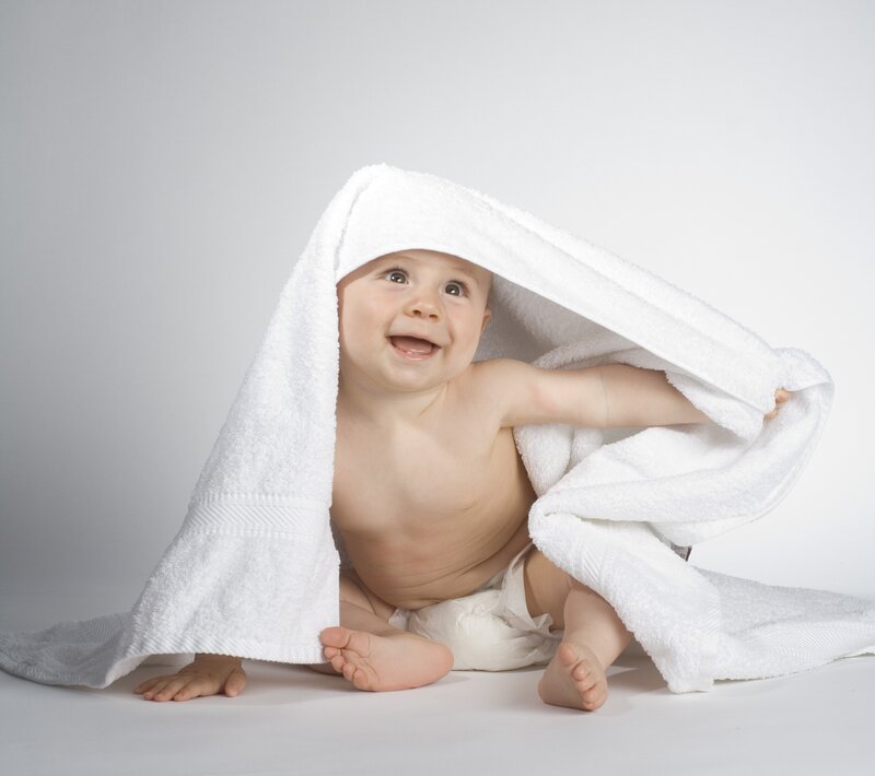 Baby in White Towel — Playful