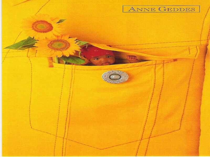 Baby in yellow pocket with sunflowers