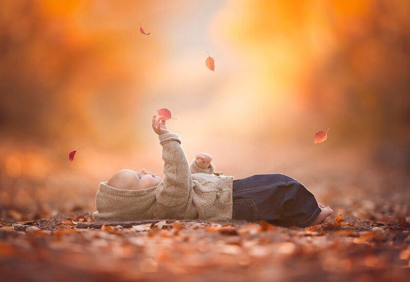 Baby Lying in Leaves