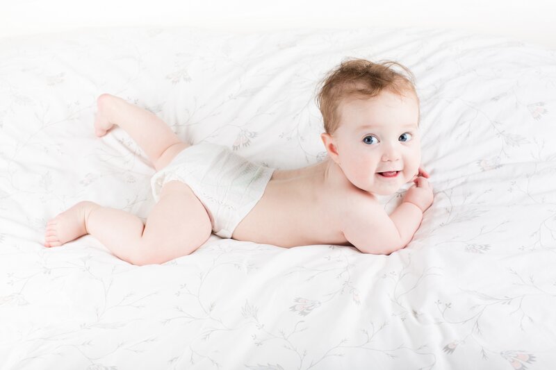Baby Lying on Bed — White