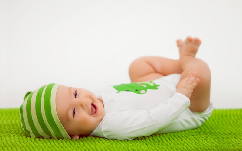Baby Lying on Green Mat