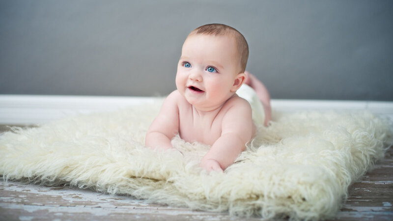 Baby Lying on Rug
