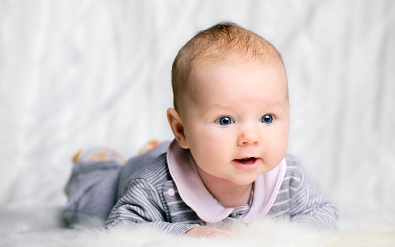 Baby Lying on Stomach — Gray, Calm, Photograph