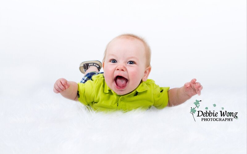 Baby Lying on White Rug