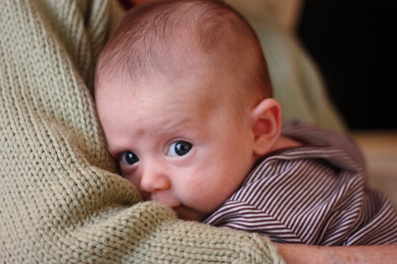 baby peeking from blanket