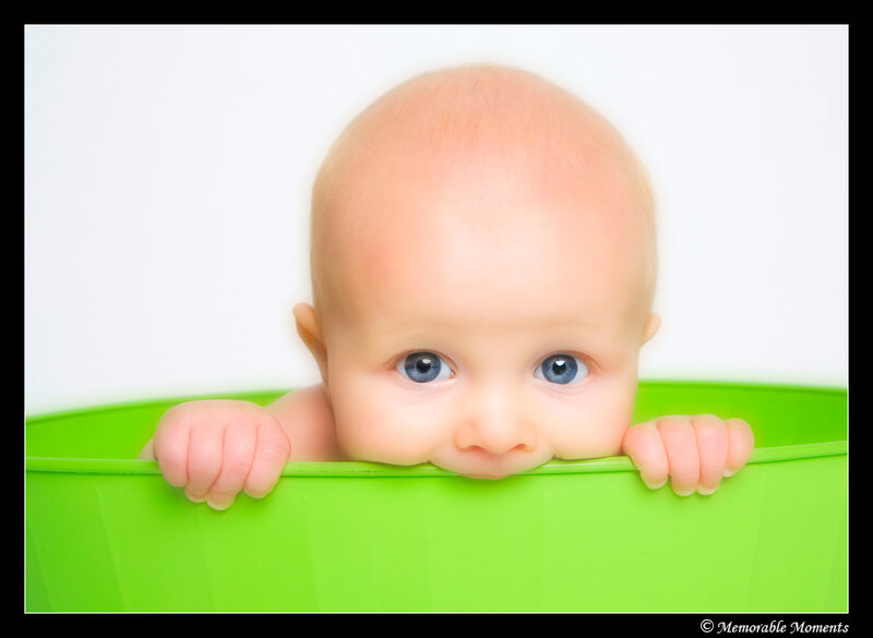 Baby Peeking over Green Tub