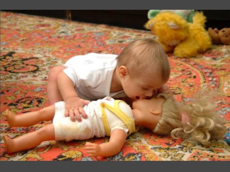 Baby playing with a doll