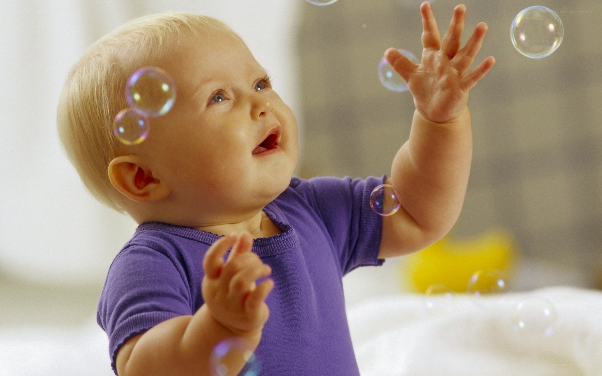baby playing with bubbles