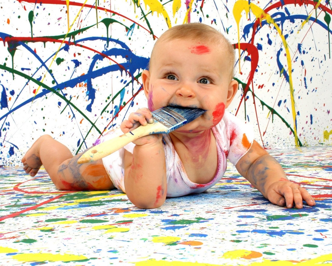 baby playing with paintbrush