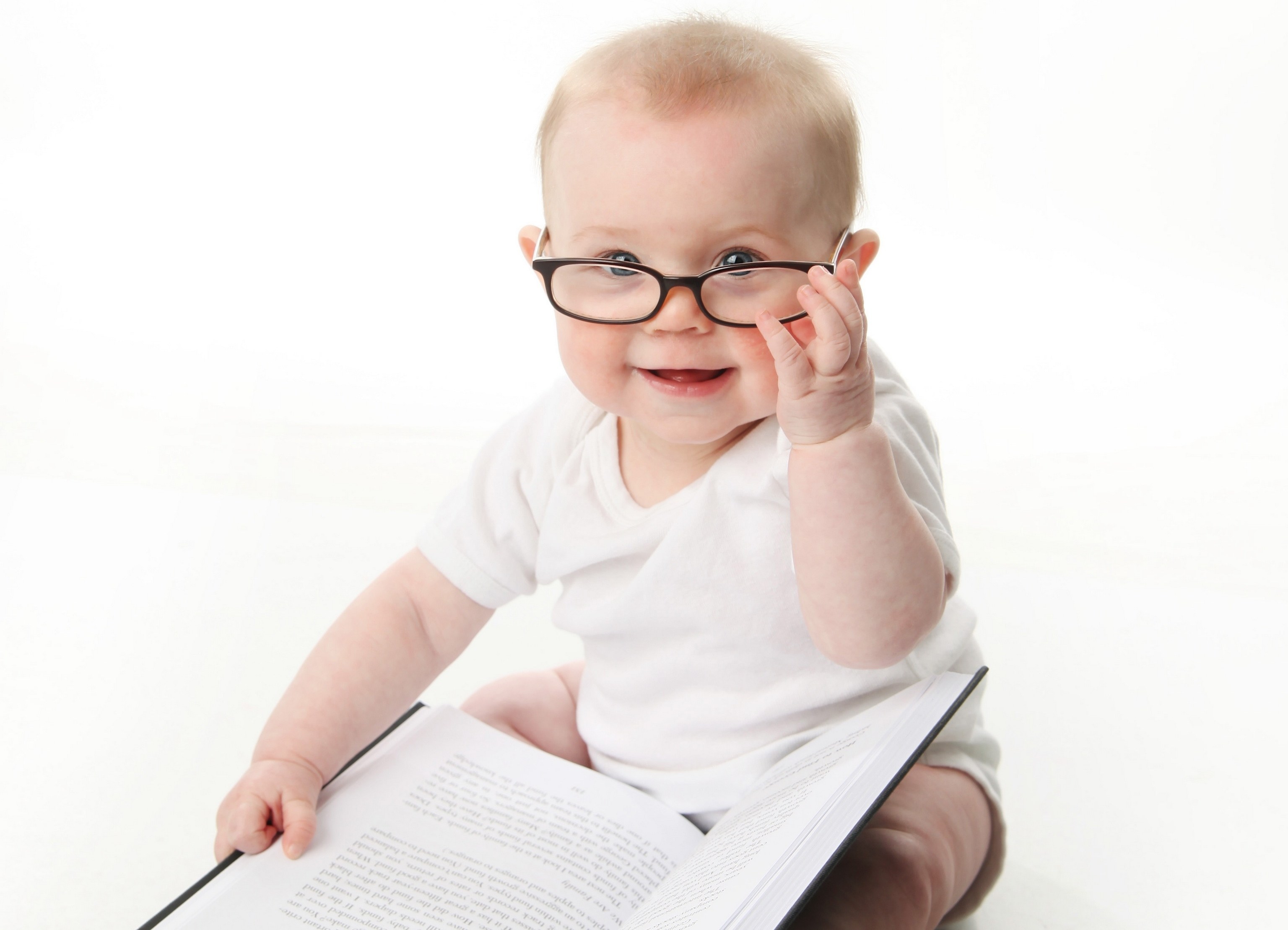 baby reading book with glasses