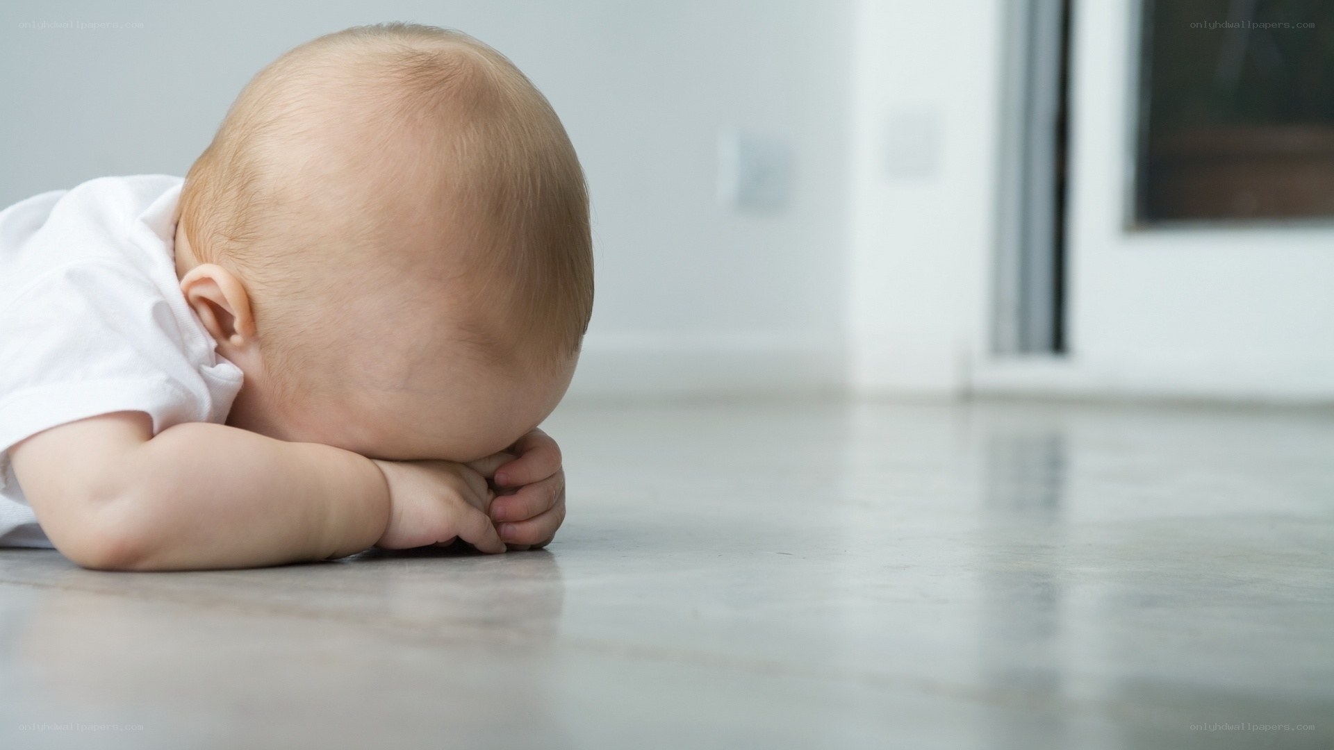Baby resting on floor