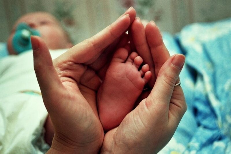 Baby's Foot in Hands
