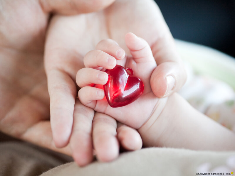 Baby's Hand Holding Heart